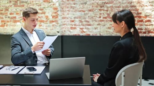 Business Meeting Professional Man and Woman Discuss a Project in Modern Office