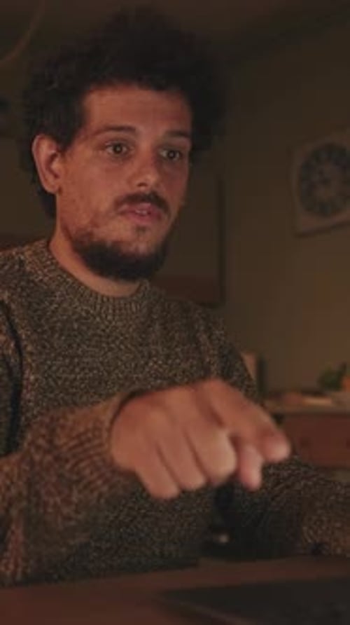 Man Speaking During Video Conference at Night