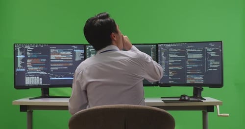 Back View Of Tired Asian Man Developer Yawning Before Sleeping While Write Code With Multiple