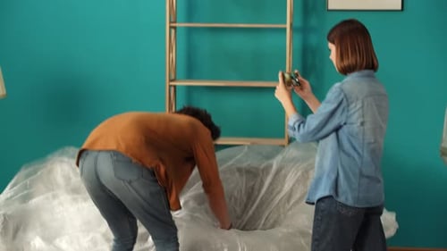 Close Up of Living Room Woman Recording Video on Smartphone Man Taking Off the Film From the Sofa in