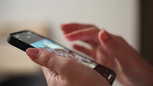 Hands Scrolling Through Phone Application