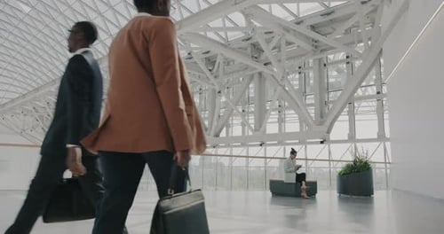 Slow Motion of Businesspeople Men and Women Walking in Modern Airport Building Carrying Bags
