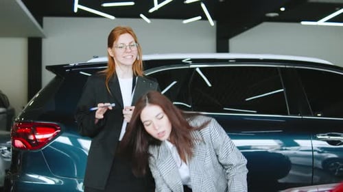 Saleswoman Guides Client Through Automobile Purchase Discussions in Dealership with Focus on Test
