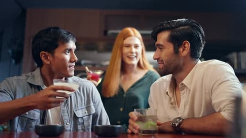 4K Group of people friends celebrating holiday event drinking cocktail together at luxury bar.