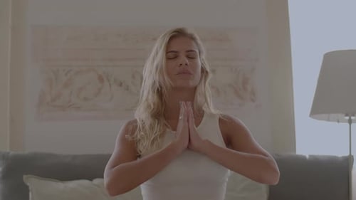 Woman Meditating Peacefully in a Bright Bedroom