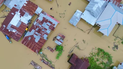 Aerial View of Flooded Village Homes and Boats