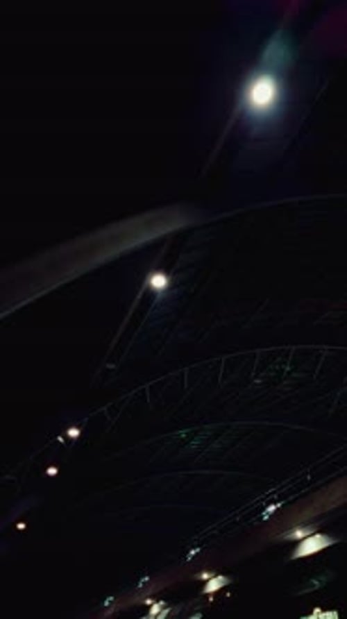 Dark architectural roof with industrial lighting at night Amsterdam Central Station