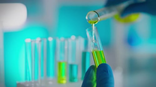 Laboratory Glassware with Liquid Being Poured