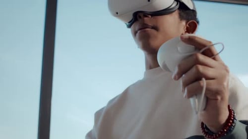 Young Adult Using VR Headset and Controllers