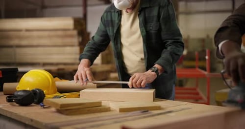 Carpenter, wood and men measure in workshop for manufacturing, furniture and building