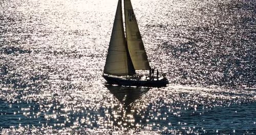 Aerial View Yacht Sailing on Open Sea at Windy Day Aerial Sun Shine Over White Sail Boat at Ocean