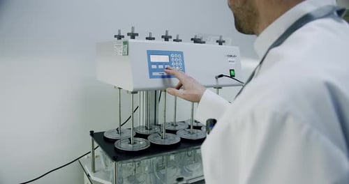 Medical research laboratory. A scientist works with a pipette and a test tube.