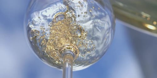 White wine pouring into a glass
