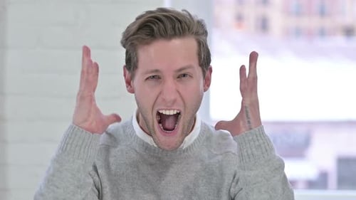 Young Man Reacting with Frustration
