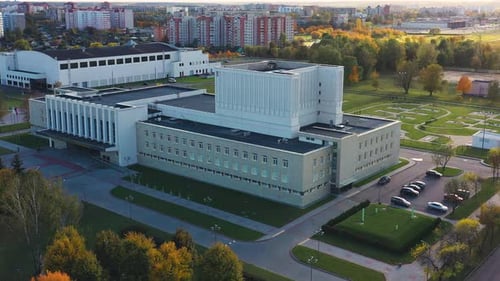 A Beautiful Aerial View of a Modern Architectural Building Surrounded By a Lush Green Landscape