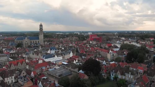 Flying over the ancient city of Bruges with a cloudy sky, Belgium, drone shot HD