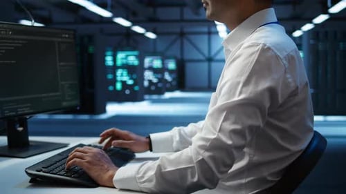 Close Up of Expert Typing on Keyboard in Server Room Coding on Computer