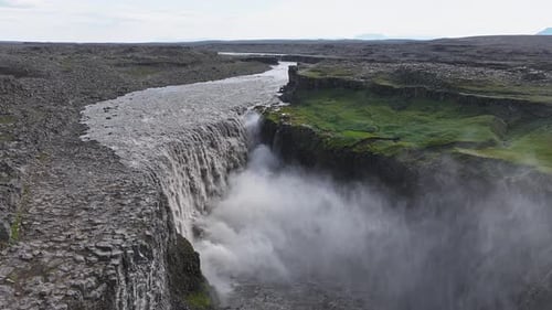 Aerial View of Dettifoss Waterfall Cascading in Iceland's Rugged Terrain