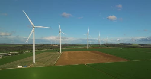 Large White Power Generators That Generate Electricity From the Wind Wind Turbines in a Field