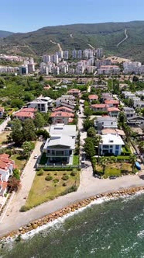 Aerial Drone Footage of Beachfront Residential Villas Along the Coast – 4K
