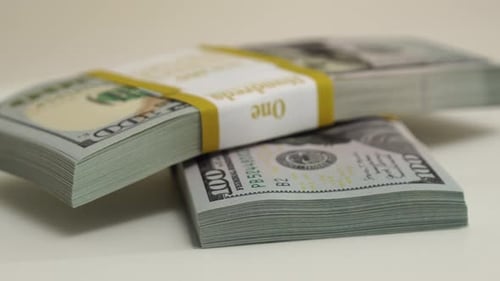 Stack of Bank Bundles with US Dollars on a White Background Closeup Shot of New Freshly Printed