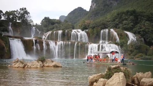 Tourists With Life Vest Riding On The Raft On The River Towards The Ban Gioc-Detian Falls (Cao Bang