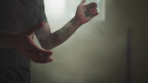 Sportsman Applies Talc Powder on Palms in Gym