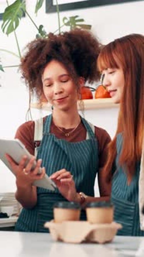 Coffee shop, talking and women on tablet in cafe for menu items, inventory and online orders
