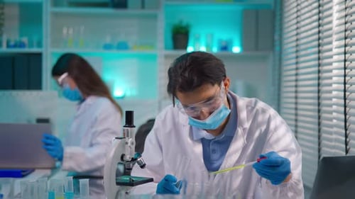 Asian male scientist working in the biotechnology research laboratory.