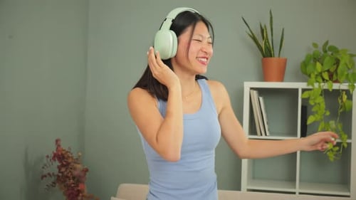 Woman Listening to Music and Dancing at Home
