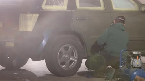 Man Sprays Paint on Car with Face Mask