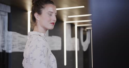 Portrait of happy caucasian casual businesswoman in office, slow motion