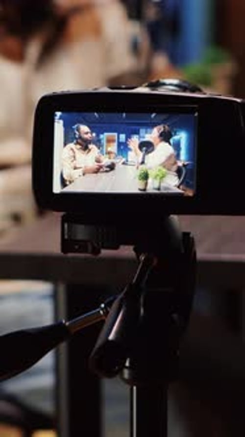 Camera pointed at Monitor broadcasting a podcast