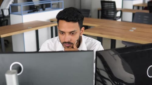 Side View of Smart Indian Crypto Trader Investor Analyst Broker Using Pc Analyzing Digital