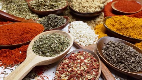 Variety of Colorful Spices and Herbs in Wooden Spoons