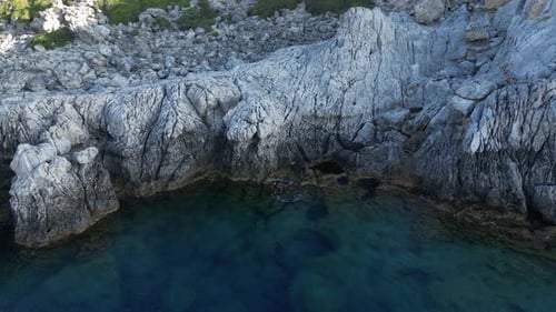 Aerial View of Rocky Coast and Blue Sea