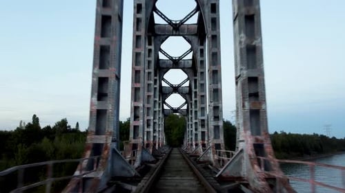 Train transporting cargo over steel bridge, POV view