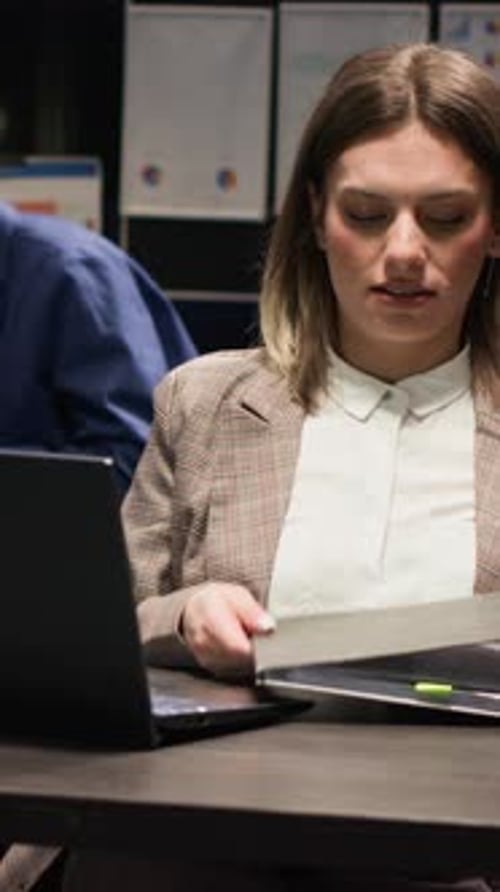 Woman Reviews Documents in Vibrant Workplace