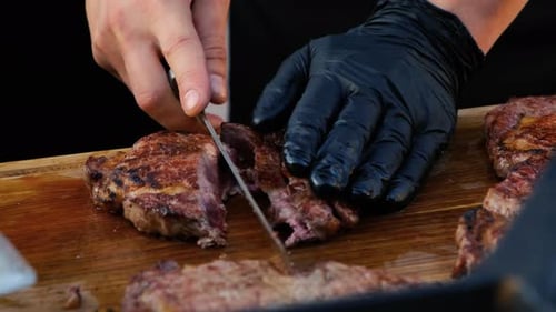 Fried Beef Steak is Cut Into Slices in a Restaurant