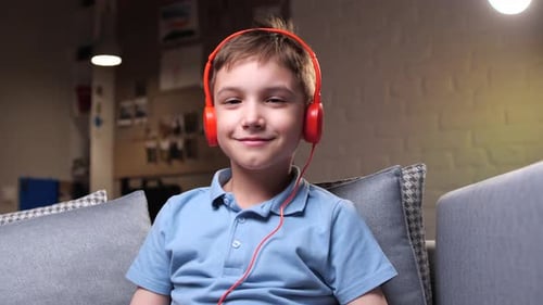 Smiling Boy Listening to Music with Headphones