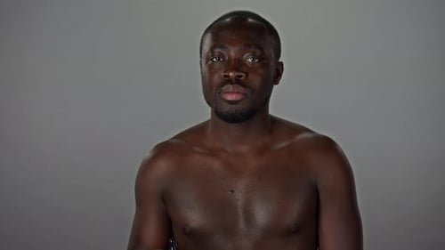 Smiling Man Holds Dropper Bottle of Serum