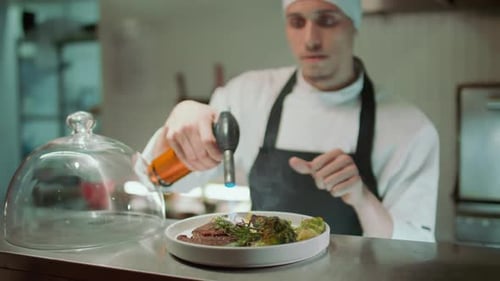 Chef Charring Food with Blow Torch before Serving in Restaurant