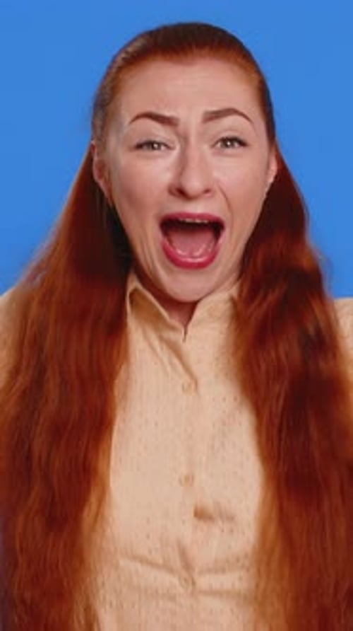 Enthusiastic Redhead Woman Smiling and Giving a Thumbs Up