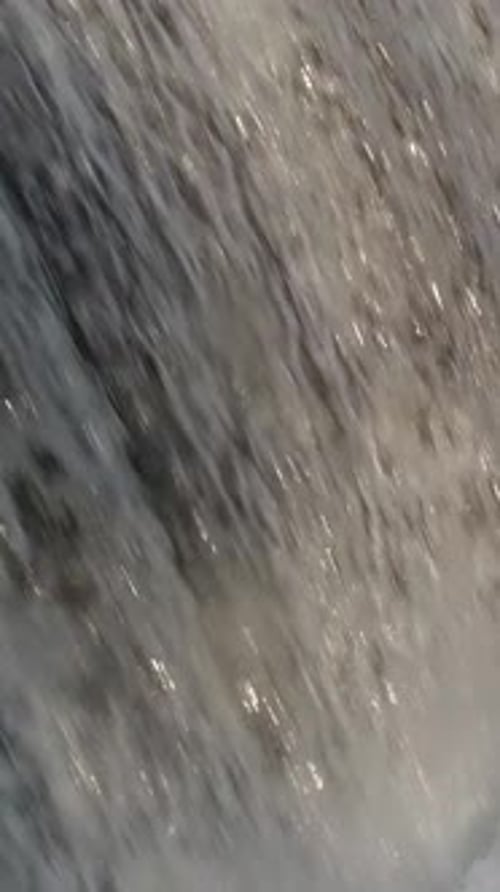 Cascading Water Over Rock in a Close Up Shot