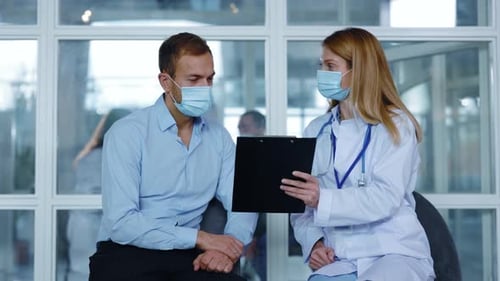 Man consulting with doctor in medical office visit