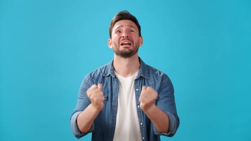 Upset Man Pleads Making Prayer Gesture and Crossing Fingers
