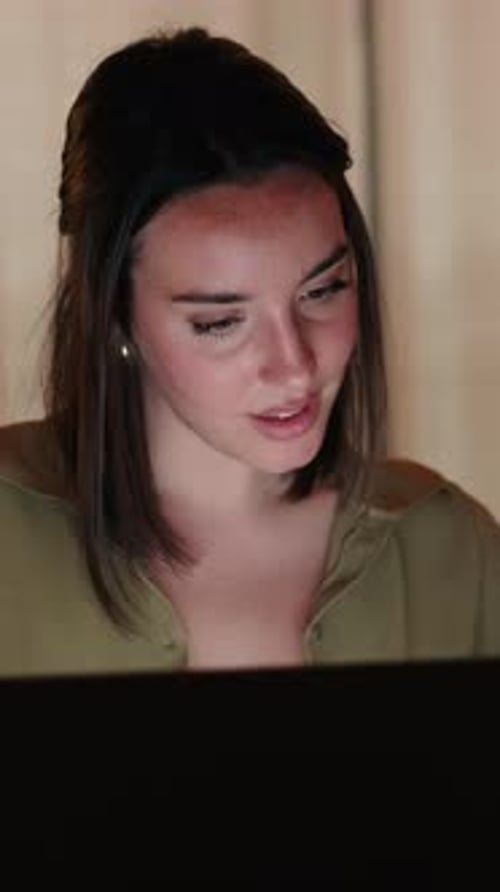 Vertical video, Close up of Woman Working From Home on Laptop at Night