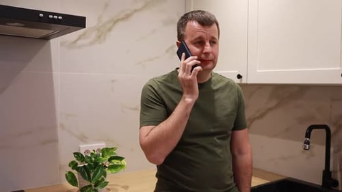 Man Having Phone Call in Kitchen