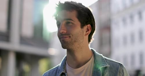 Smiling Young Man in Denim Jacket on City Street