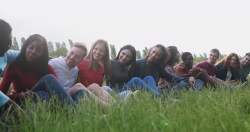 Diverse group of friends enjoying a sunny summer picnic in a USA park